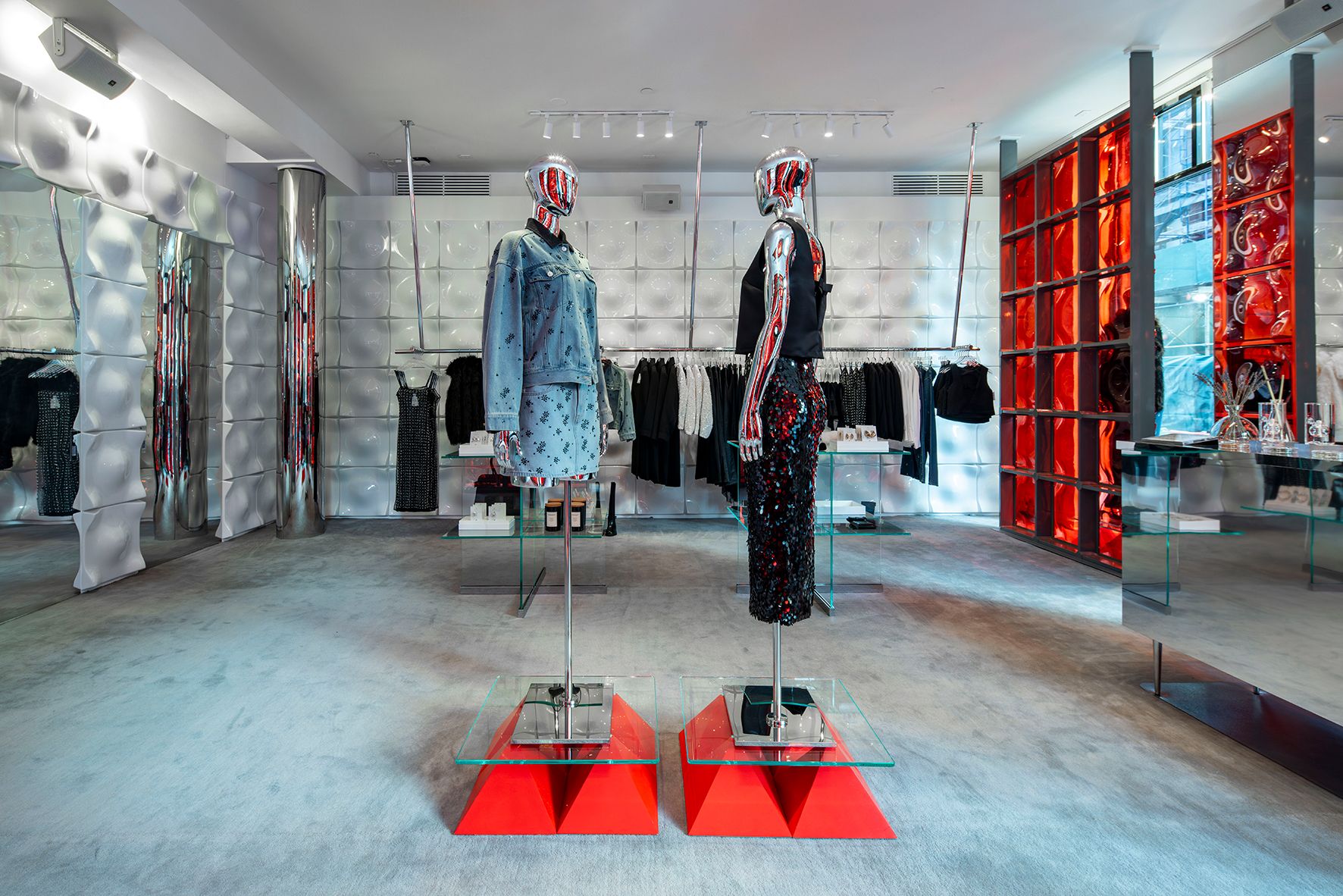 H&M retail interior with chrome mannequins and red accents